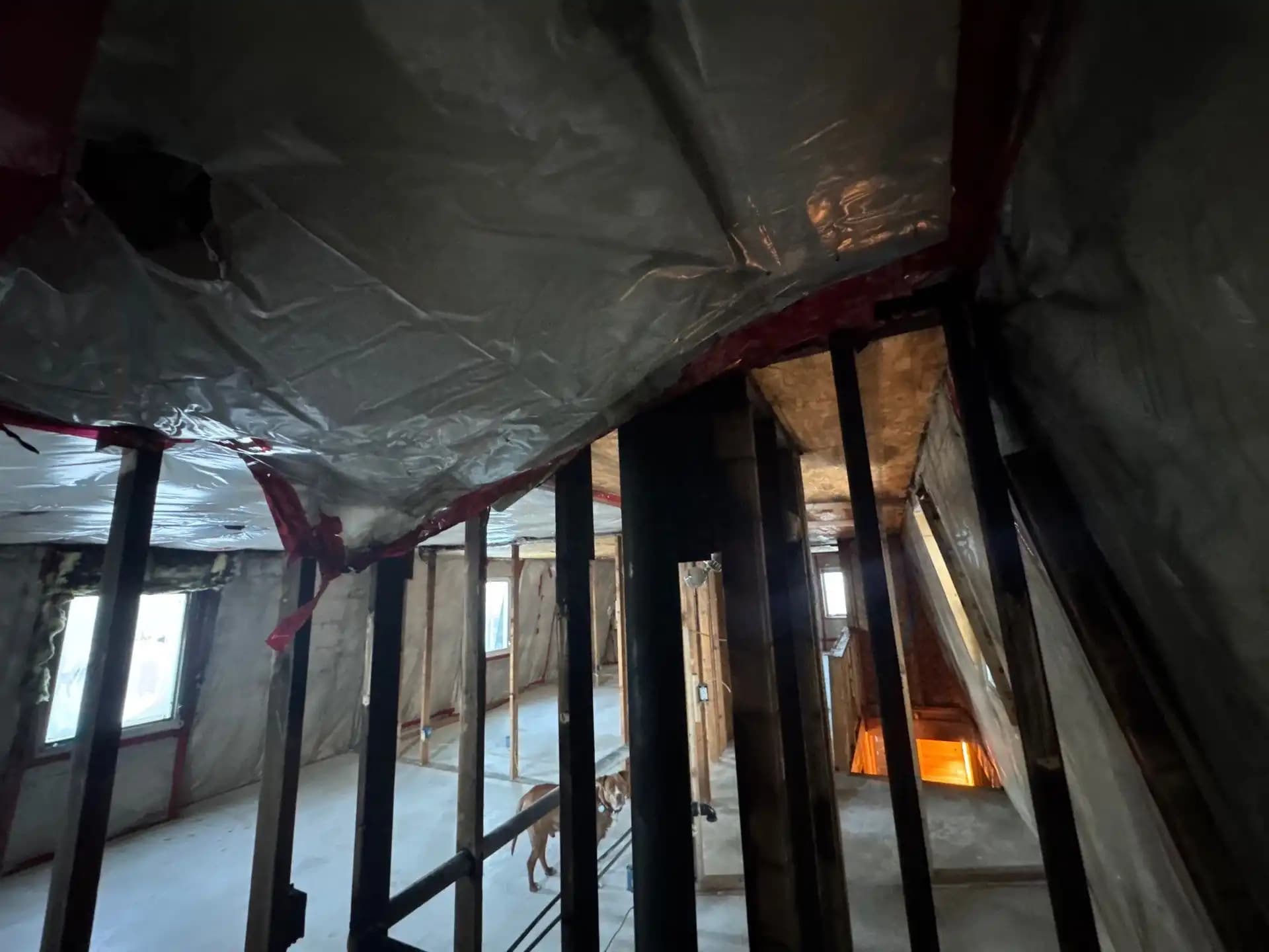 Technician inspecting smoke and soot damage inside a property